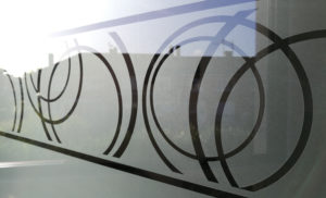 Adhésif dépoli gris avec motif cercles posé sur une fenêtre